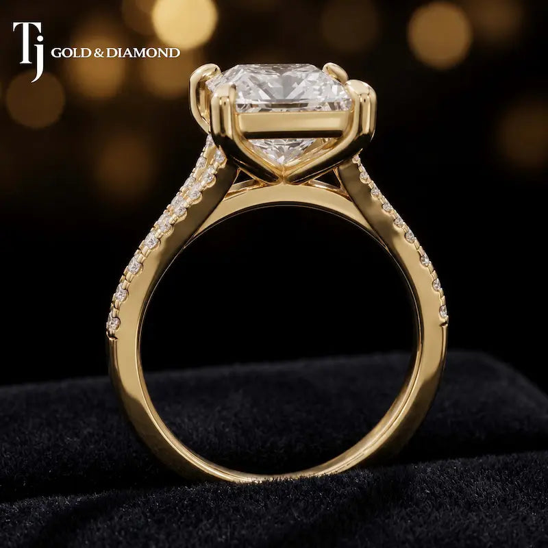 Side view of a princess cut split shank lab-grown diamond engagement ring featuring a four-claw cathedral setting in 18kt yellow gold.