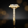 Side profile of a radiant cut halo lab-grown diamond engagement ring in 18kt yellow gold.