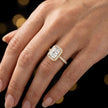 Radiant cut halo lab-grown diamond engagement ring worn on hand in 18kt yellow gold.