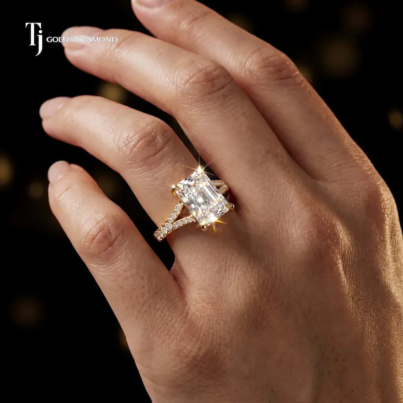 Radiant cut split shank lab-grown diamond engagement ring worn on hand in 18kt yellow gold.