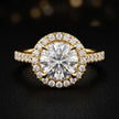 Front view of a round cut halo lab-grown diamond engagement ring in 18kt yellow gold.