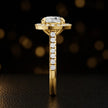 Side profile of a round cut halo lab-grown diamond engagement ring in 18kt yellow gold.