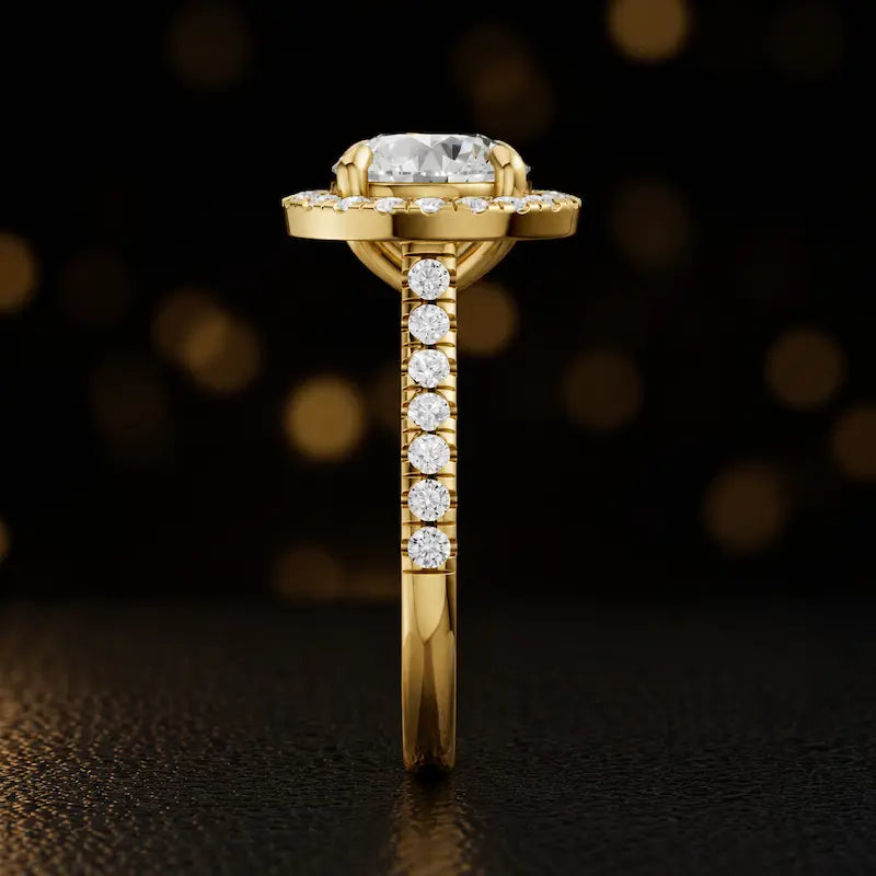 Side profile of a round cut halo lab-grown diamond engagement ring in 18kt yellow gold.