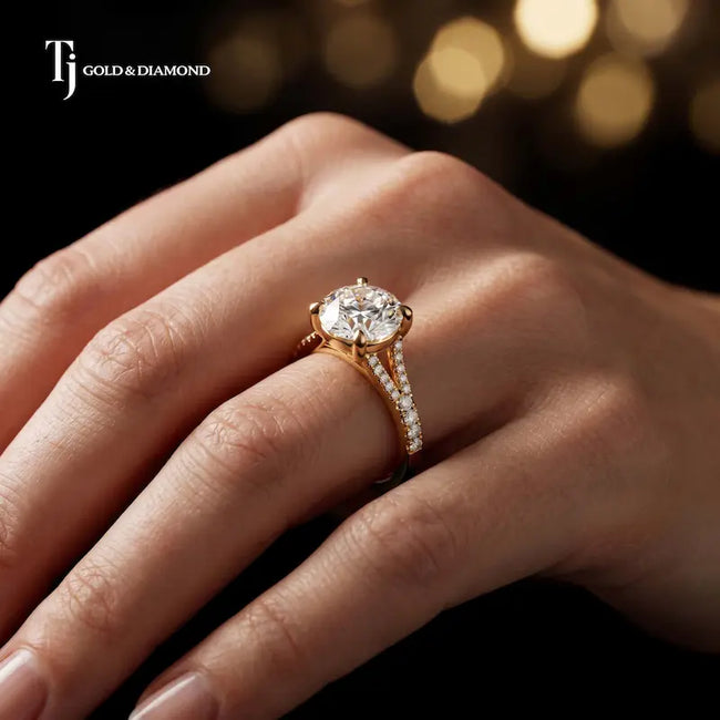 Round cut split shank lab-grown diamond engagement ring worn on hand in 18kt yellow gold.