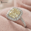 Close-up of a Cushion Cut Fancy Yellow Lab-Grown Diamond Halo Ring in 18kt white gold highlighting the cushion cut fancy yellow centre diamond and brilliant diamond halo.