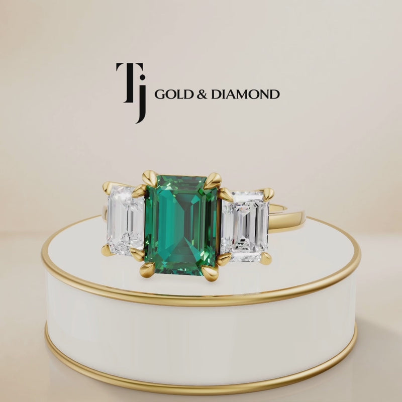 360° product view of an Emerald Cut Lab-Created Emerald & Lab-Grown Diamond Trilogy Ring in 18kt yellow gold.