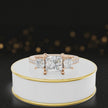 360-degree spinning view of a princess cut three-stone lab-grown diamond engagement ring in 18kt rose gold with diamond shoulders