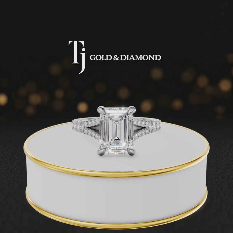360° product view of an emerald cut split shank lab-grown diamond engagement ring in 18kt white gold featuring an emerald-cut centre diamond, classic four-claw cathedral setting and diamond-set split shank.