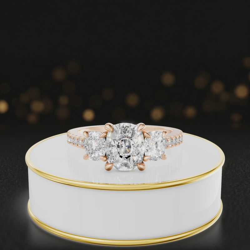 360-degree rotating view of a cushion cut three-stone diamond engagement ring in 18kt rose gold with diamond shoulders.