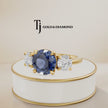 360° rotating view of a Round Cut Lab-Created Blue Sapphire & Lab-Grown Diamond Trilogy Ring in 18kt yellow gold featuring a royal blue round sapphire and round brilliant lab-grown diamond trilogy setting.