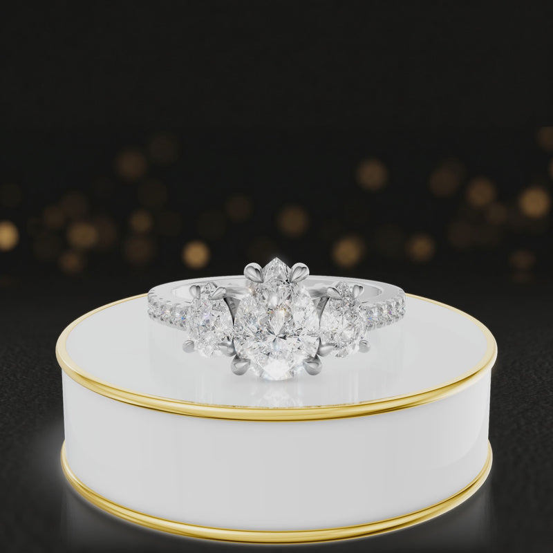 360-degree spinning view of a pear cut three-stone lab-grown diamond engagement ring in 18kt white gold with diamond shoulders