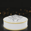 360-degree spinning view of a pear cut three-stone lab-grown diamond engagement ring in 18kt white gold with diamond shoulders