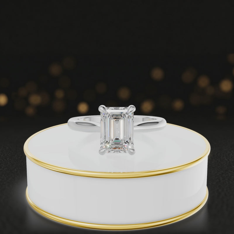 360-degree rotating view of a 1.5 carat emerald cut diamond solitaire engagement ring in an 18kt white gold 4 claw setting by TJ Diamond