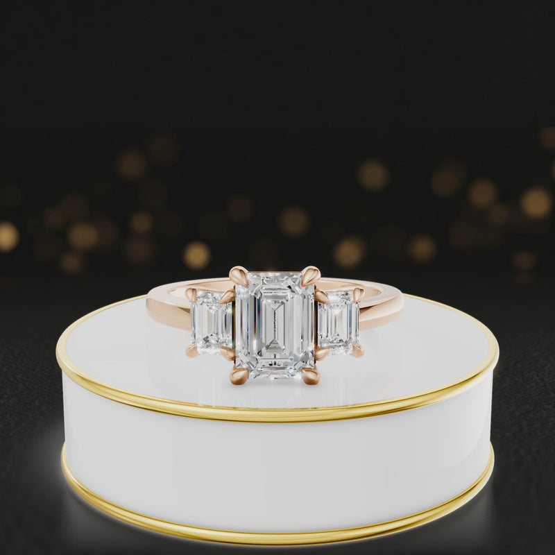 360° rotating view of an emerald-cut lab-grown diamond trilogy engagement ring in 18ct rose gold, featuring three emerald-cut lab-grown diamonds.