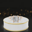 360° rotating view of an emerald-cut lab-grown diamond trilogy engagement ring in 18ct rose gold, featuring three emerald-cut lab-grown diamonds.