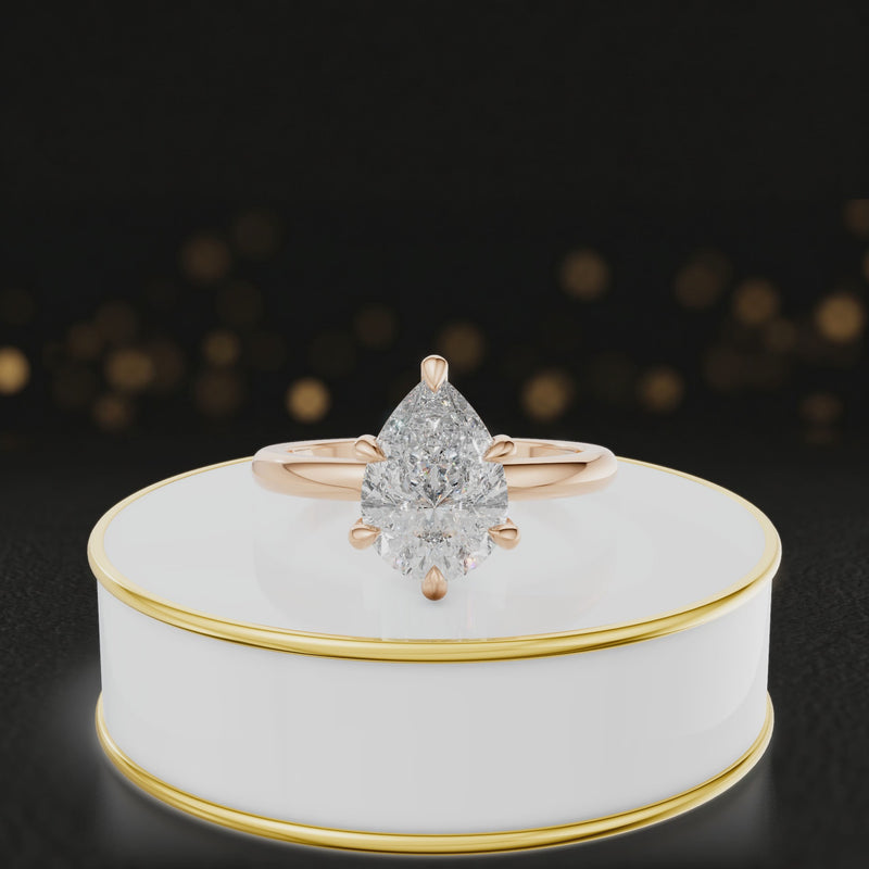 360-degree rotating view of a 1.5 carat pear cut diamond solitaire engagement ring in an 18kt rose gold 6 claw setting by TJ Diamond