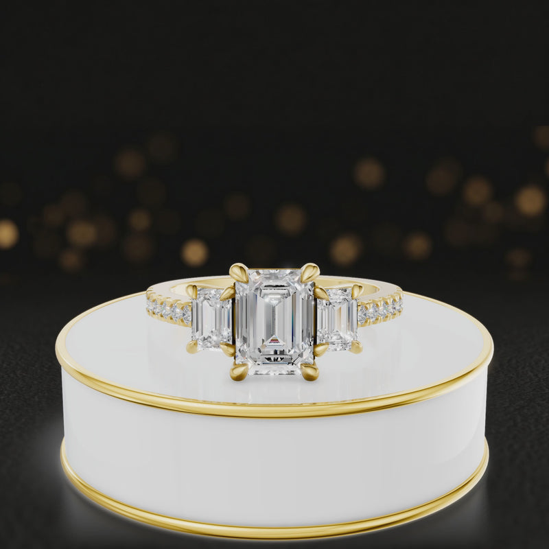 360-degree rotating view of an emerald cut three-stone lab-grown diamond engagement ring in 18kt yellow gold with diamond shoulders