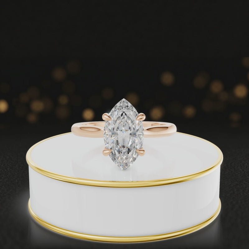 360-degree rotating view of a 1.5 carat marquise cut diamond solitaire engagement ring in an 18kt rose gold 4 claw setting by TJ Diamond