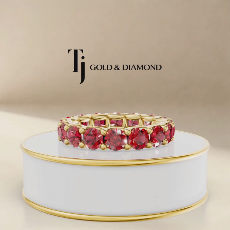 360° product view of a created ruby full eternity ring in 18kt yellow gold with round brilliant lab-created rubies.