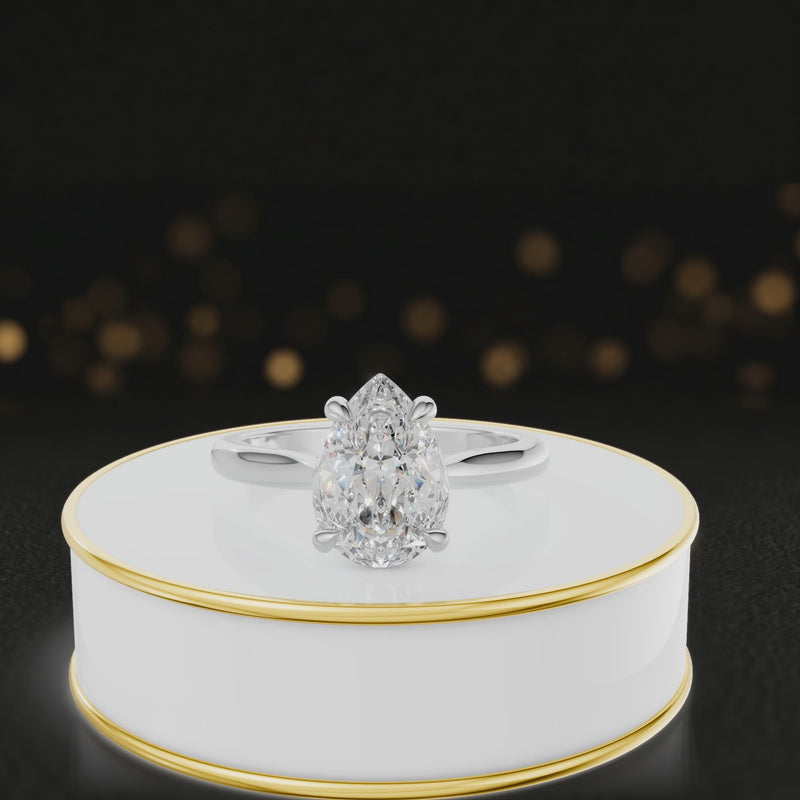 360-degree rotating view of a 1.5 carat pear cut diamond solitaire engagement ring in an 18kt white gold 4 claw setting by TJ Diamond
