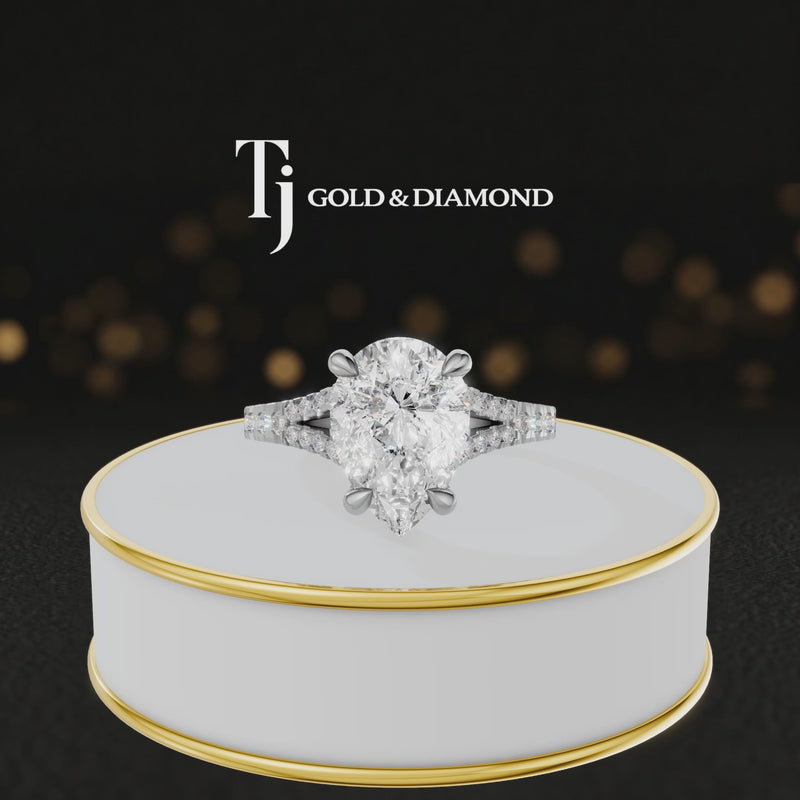 360° product view of a pear cut split shank lab-grown diamond engagement ring in 18kt white gold featuring a pear-cut centre diamond, classic four-claw cathedral setting and diamond-set split shank.