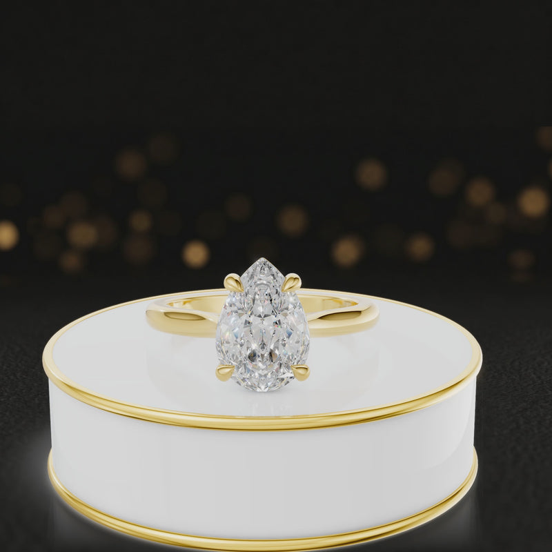 360-degree rotating view of a 1.5 carat pear cut diamond solitaire engagement ring in an 18kt yellow gold 4 claw setting by TJ Diamond