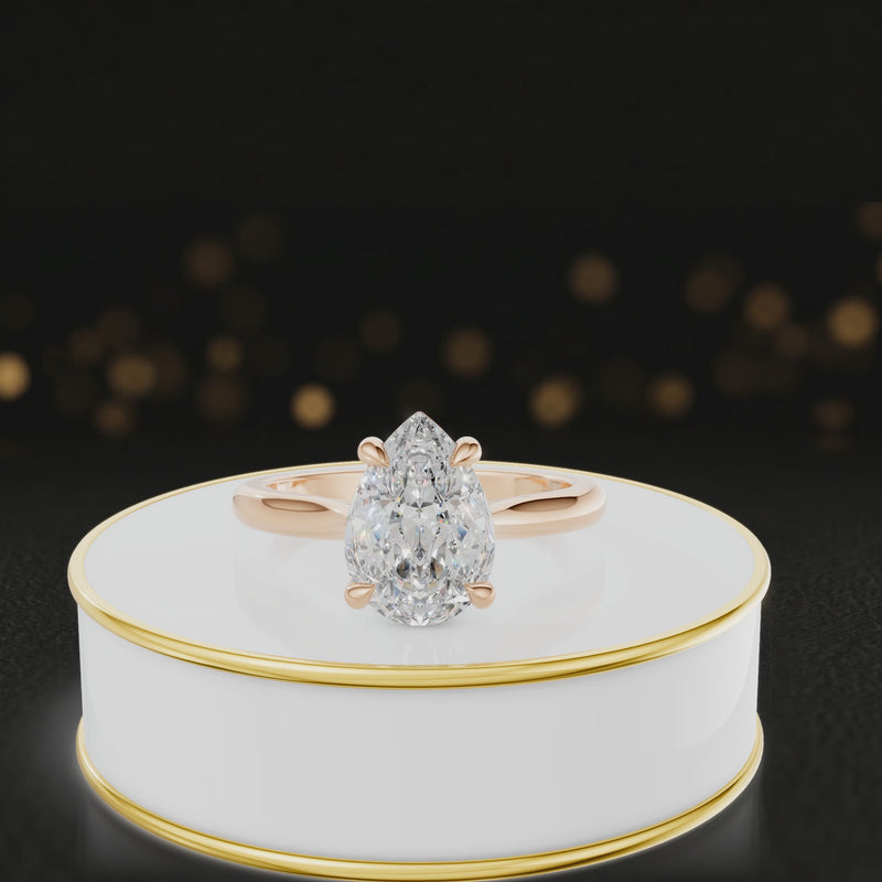 360-degree rotating view of a 1.5 carat pear cut diamond solitaire engagement ring in an 18kt rose gold 4 claw setting by TJ Diamond