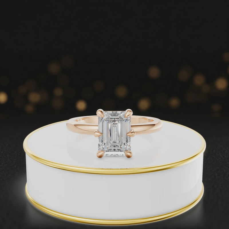 360-degree rotating view of a 1.5 carat emerald cut diamond solitaire engagement ring in an 18kt rose gold 6 claw setting by TJ Diamond