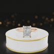 360-degree rotating view of a 1.5 carat emerald cut diamond solitaire engagement ring in an 18kt rose gold 6 claw setting by TJ Diamond