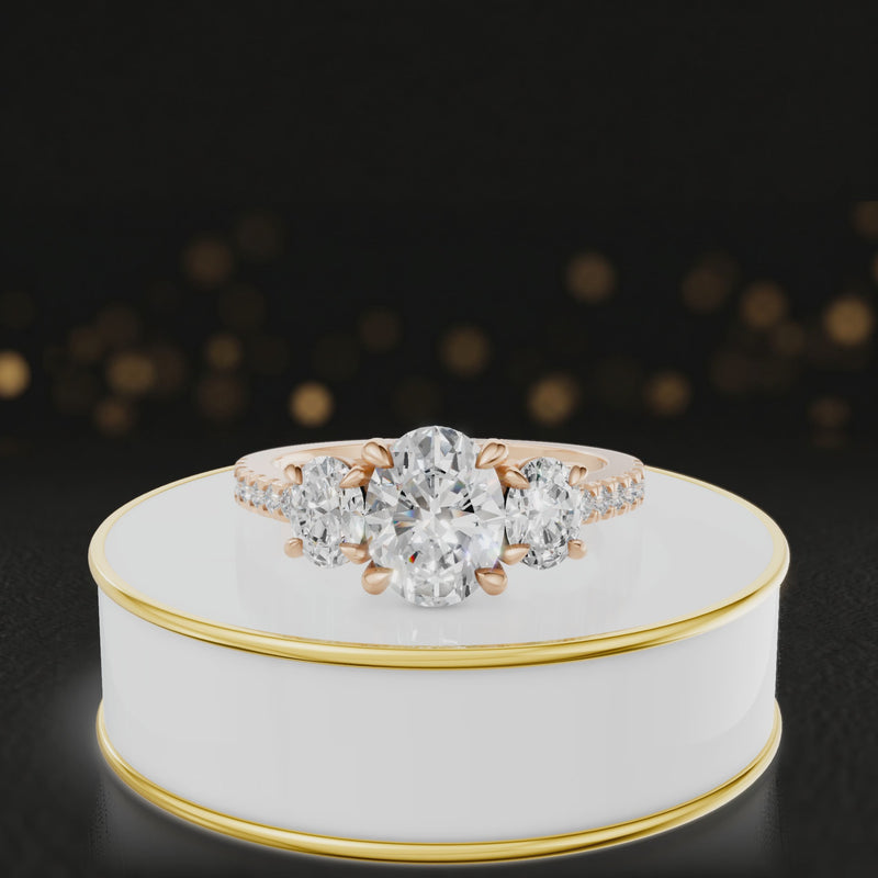 360-degree spinning view of an oval cut three-stone lab-grown diamond engagement ring in 18kt rose gold with diamond shoulders