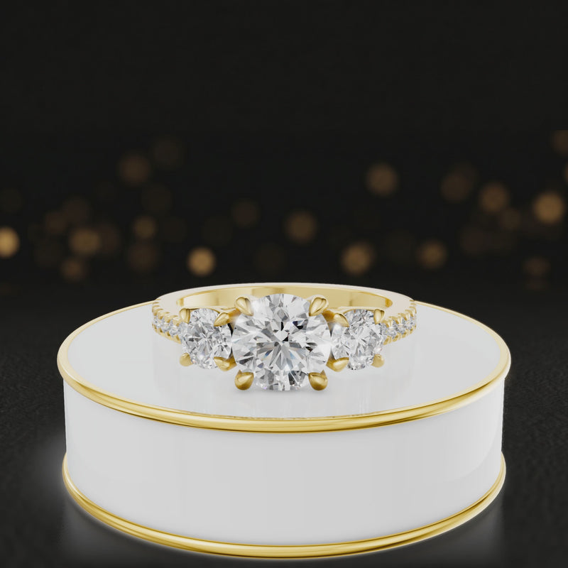 360-degree spinning view of a round cut three-stone lab-grown diamond engagement ring in 18kt yellow gold with diamond shoulders