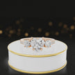 360-degree rotating view of a heart cut three-stone lab-grown diamond engagement ring in 18kt rose gold with diamond shoulders