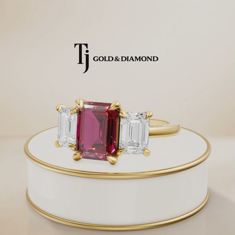 360° product view of an emerald cut lab-created ruby trilogy engagement ring in 18kt yellow gold with emerald cut lab-grown diamond side stones and a classic four claw basket setting.