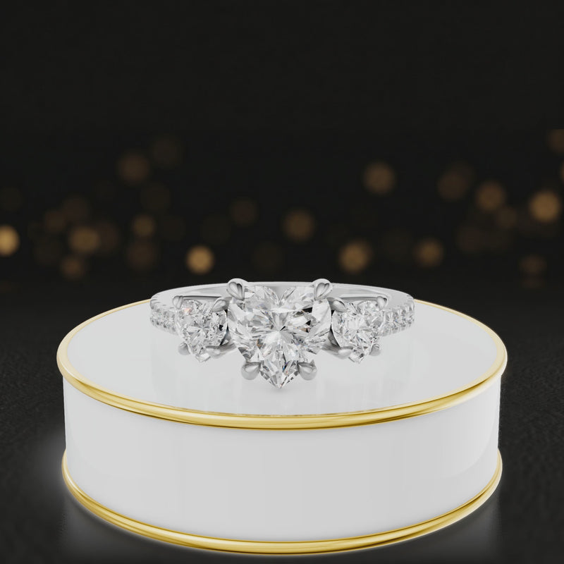 360-degree spinning view of a heart cut three-stone lab-grown diamond engagement ring in 18kt white gold with diamond shoulders