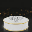 360-degree spinning view of a heart cut three-stone lab-grown diamond engagement ring in 18kt white gold with diamond shoulders