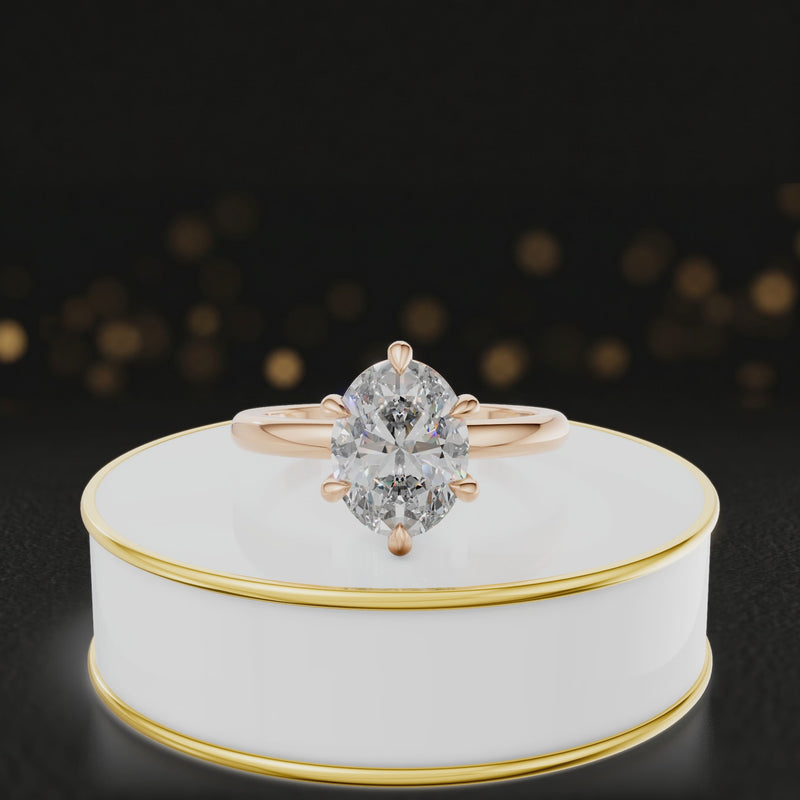 360-degree rotating view of a 1.5 carat oval cut diamond solitaire engagement ring in an 18kt rose gold 6 claw setting by TJ Diamond