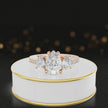 360-degree spinning view of a pear cut three-stone lab-grown diamond engagement ring in 18kt rose gold with diamond shoulders