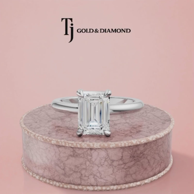 360-degree spinning view of a 1.5 carat emerald cut lab-grown diamond solitaire engagement ring in 18kt white gold with a 4-claw setting