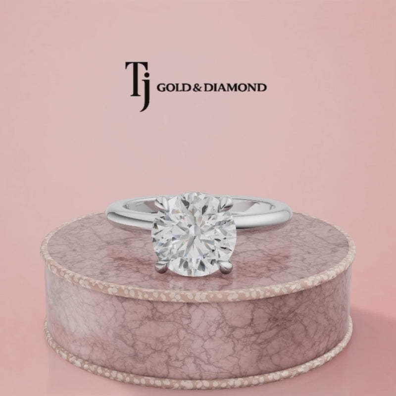 360-degree rotating view of a 1.5 carat round cut lab-grown diamond solitaire engagement ring in 18kt white gold with a 4-claw setting