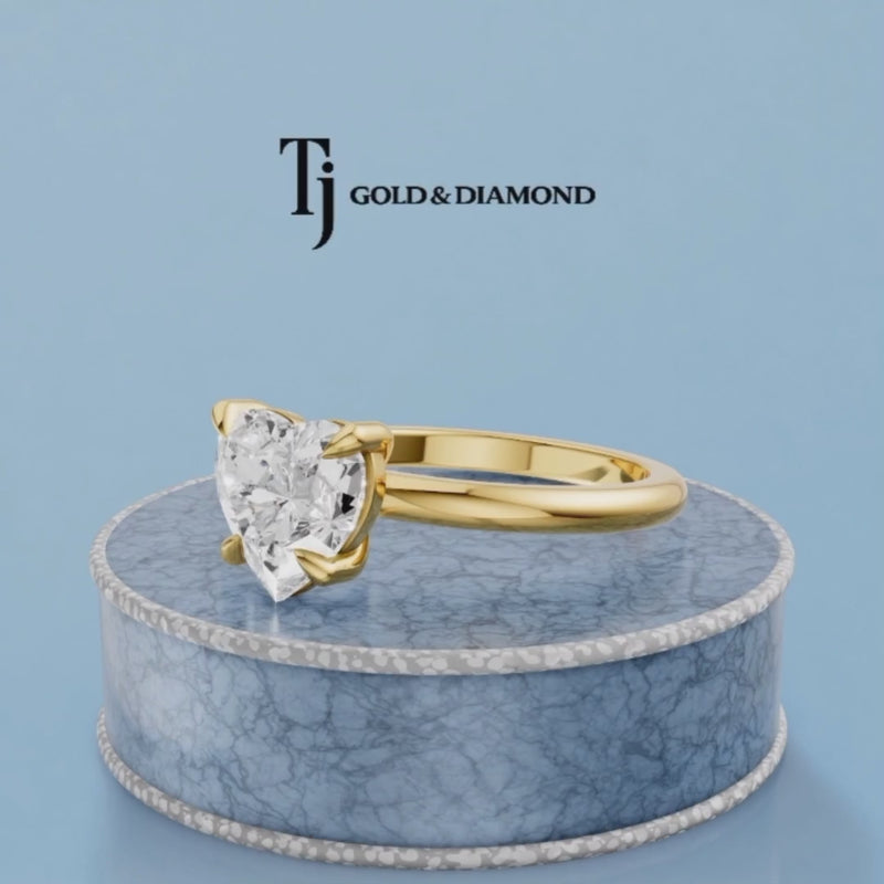 360-degree rotating view of a 1.5 carat heart cut lab-grown diamond solitaire engagement ring in 18kt yellow gold with a 4-claw setting