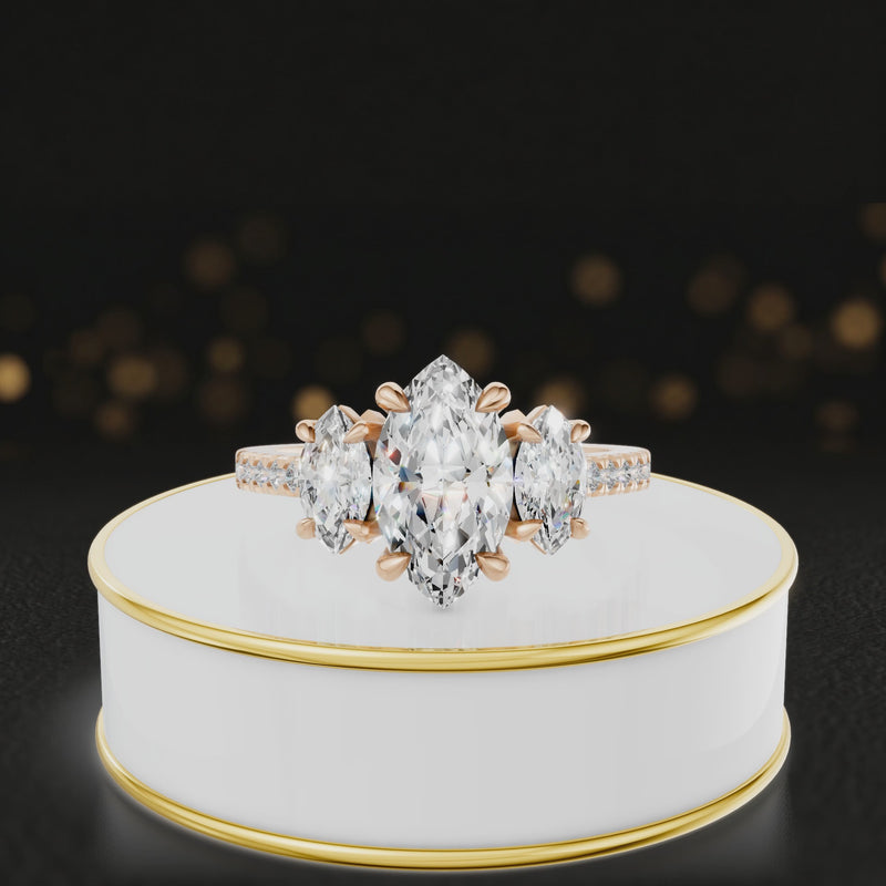 360-degree spinning view of a marquise cut three-stone lab-grown diamond engagement ring in 18kt rose gold with diamond shoulders