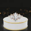 360-degree spinning view of a marquise cut three-stone lab-grown diamond engagement ring in 18kt rose gold with diamond shoulders