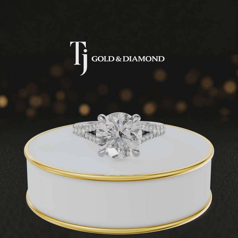 360° product view of a round cut split shank lab-grown diamond engagement ring in 18kt white gold featuring a round brilliant centre diamond, classic four-claw cathedral setting and diamond-set split shank.