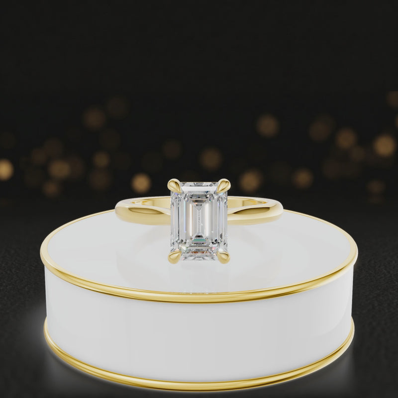 360-degree rotating view of a 1.5 carat emerald cut diamond solitaire engagement ring in an 18kt yellow gold 4 claw setting by TJ Diamond
