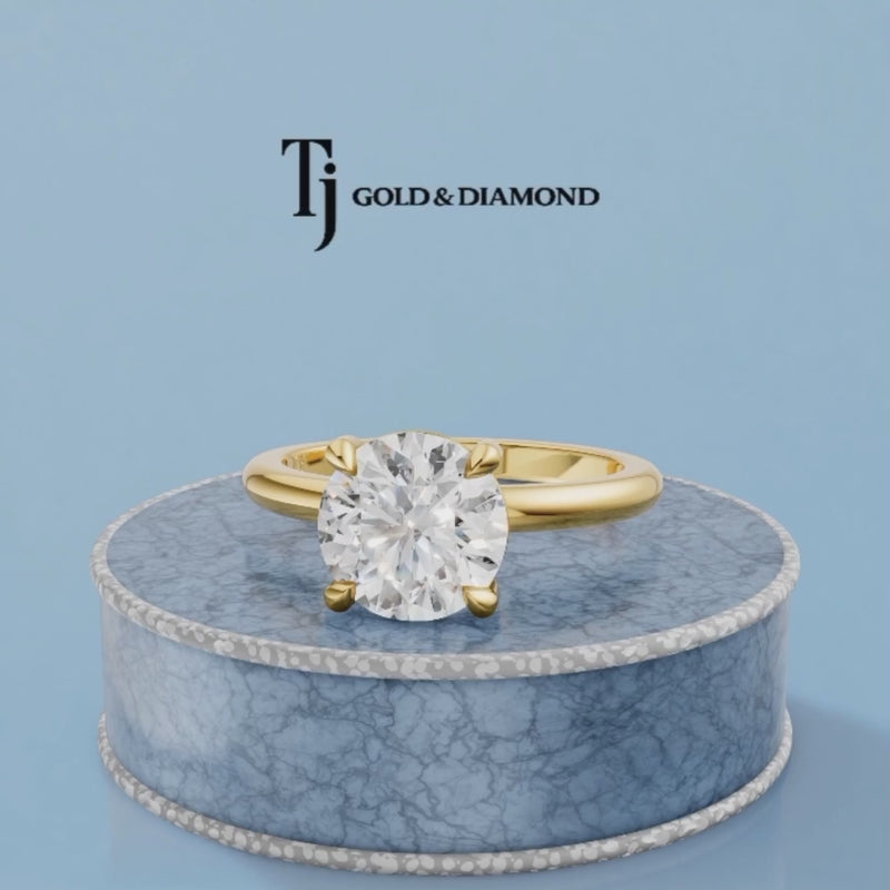 360-degree rotating view of a 1.5 carat round cut lab-grown diamond solitaire engagement ring in 18kt yellow gold with a 4-claw setting