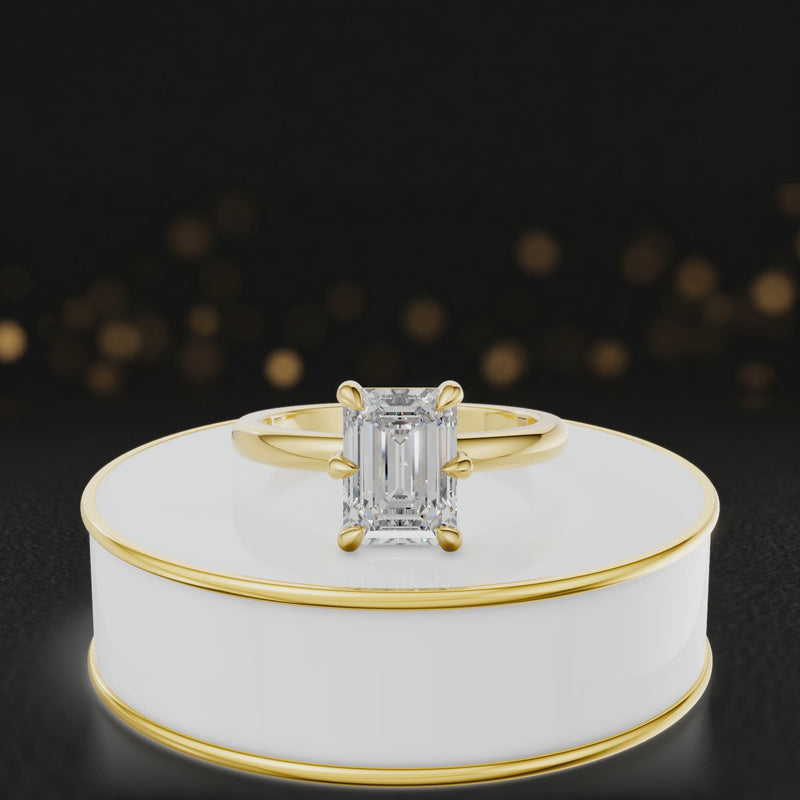 360-degree rotating view of a 1.5 carat emerald cut diamond solitaire engagement ring in an 18kt yellow gold 6 claw setting by TJ Diamond