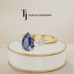 360° product view of a Pear Cut Lab-Created Blue Sapphire & Lab-Grown Diamond Trilogy Ring in 18kt yellow gold featuring a pear-shaped royal blue sapphire with pear-shaped lab-grown diamond side stones.