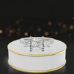 360-degree spinning view of a princess cut three-stone lab-grown diamond engagement ring in 18kt white gold with diamond shoulders.