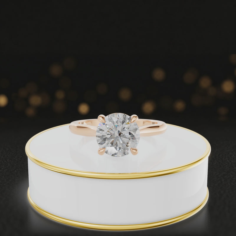 360-degree rotating view of a 1.5 carat round brilliant cut diamond solitaire engagement ring in an 18kt rose gold 4 claw setting by TJ Diamond