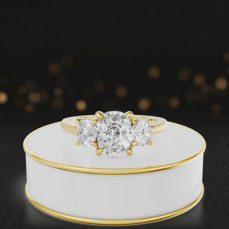 360° rotating view of a cushion-cut lab-grown diamond trilogy engagement ring in 18ct yellow gold, featuring three cushion brilliant lab-grown diamonds.